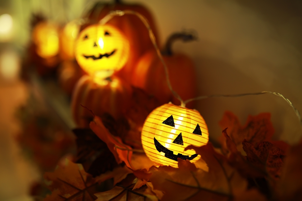 Glowing Jack-O'-Lanterns Amid Autumn Leaves: Festive Halloween Decor