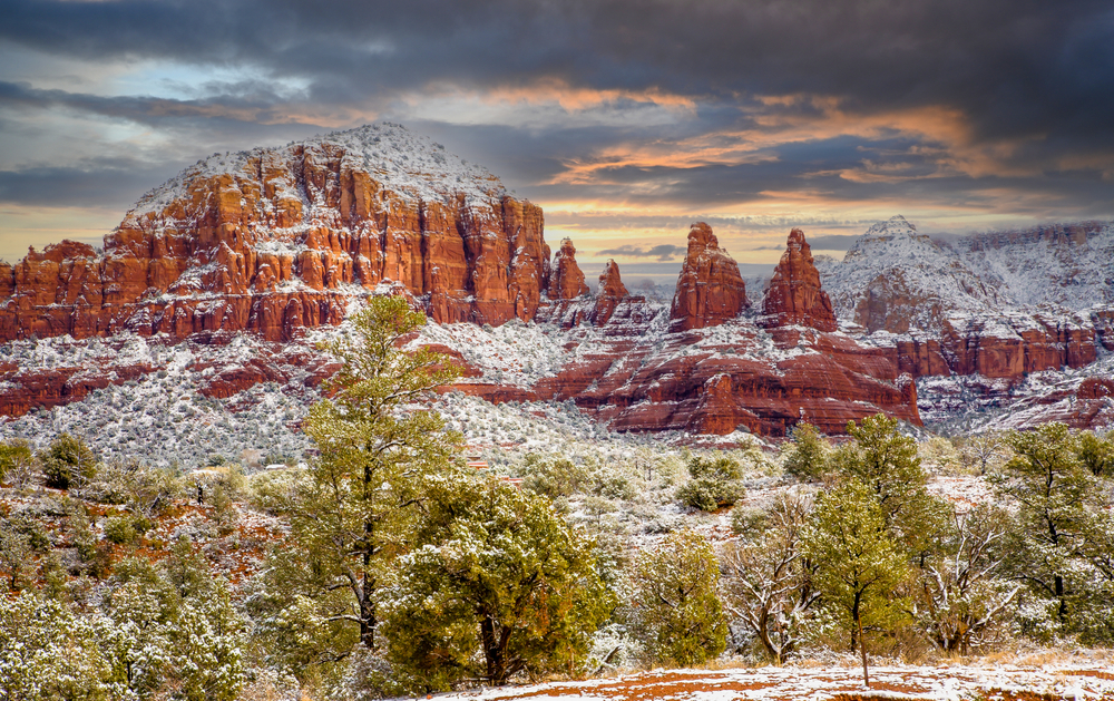 Sunset behing the snow covered red rocks near Sedona, Arizona afer a light snow fall.