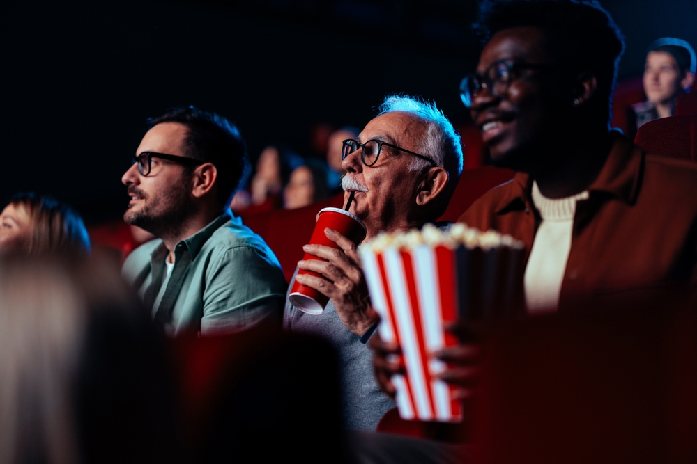 Older man at the movies enjoying a new film.